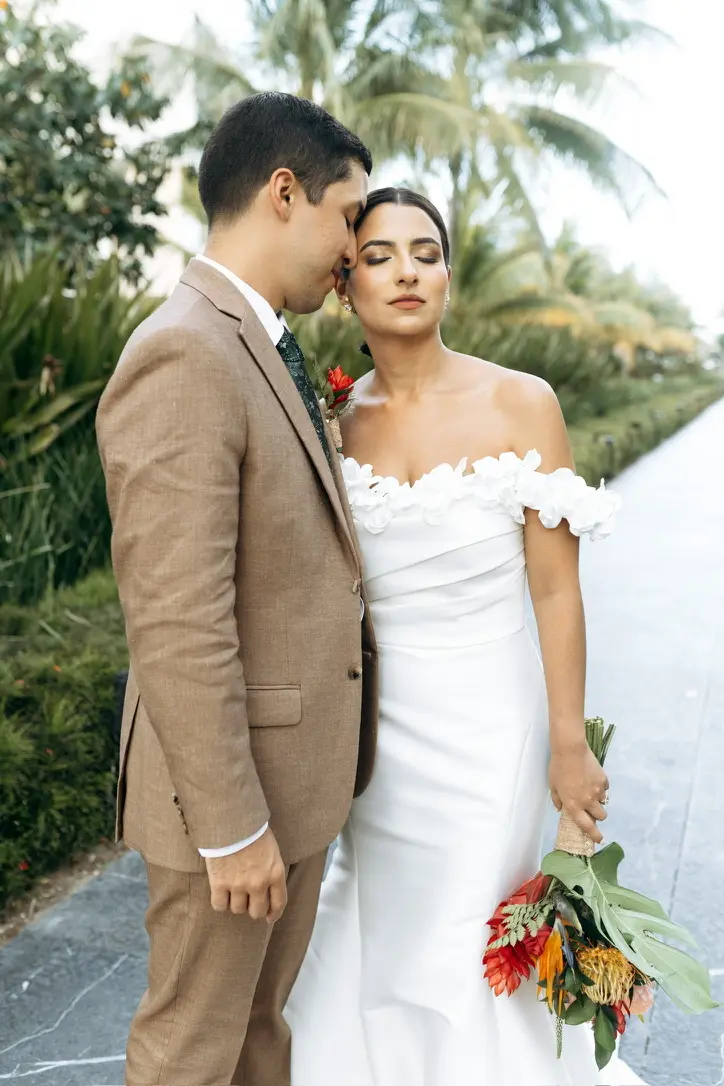Erika and Marcos posing for pictures before the wedding ceremony Dreams playa Mujeres Cancun