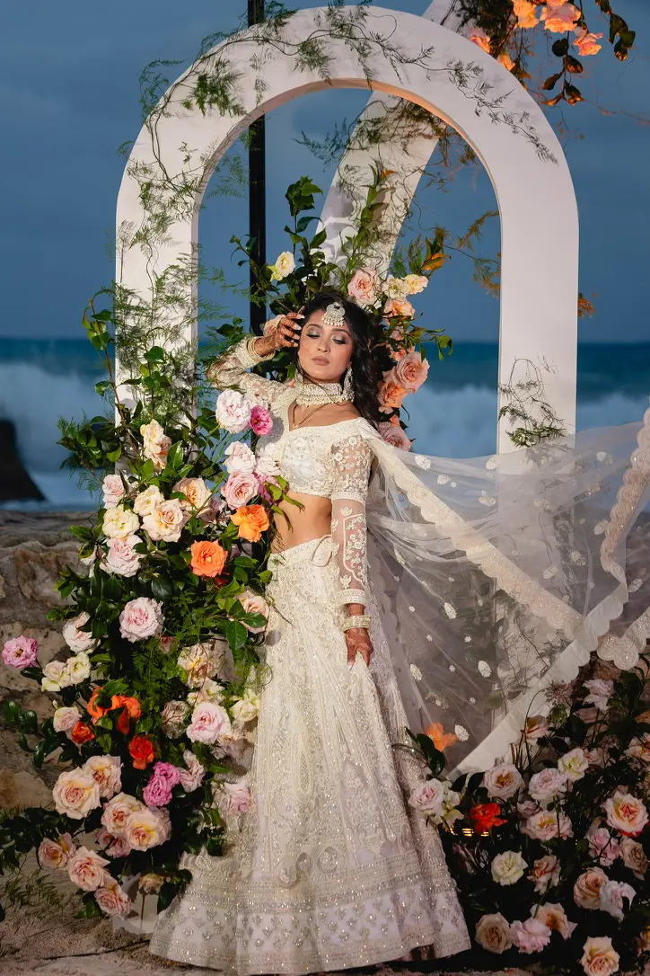 multi day sophisticated hindu wedding couple taking photo at mandap decoration at Edition Riviera Maya