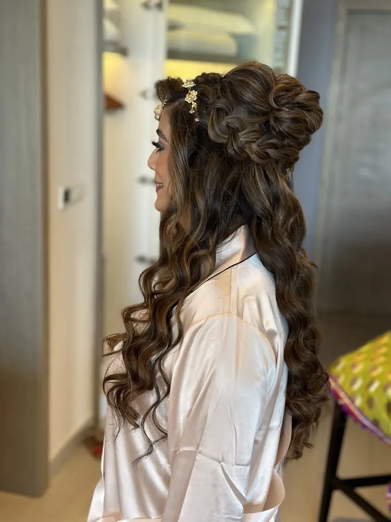 Pakistani bride wears a high curly bun and half-down in waves for her wedding at planet hollkywood cancun
