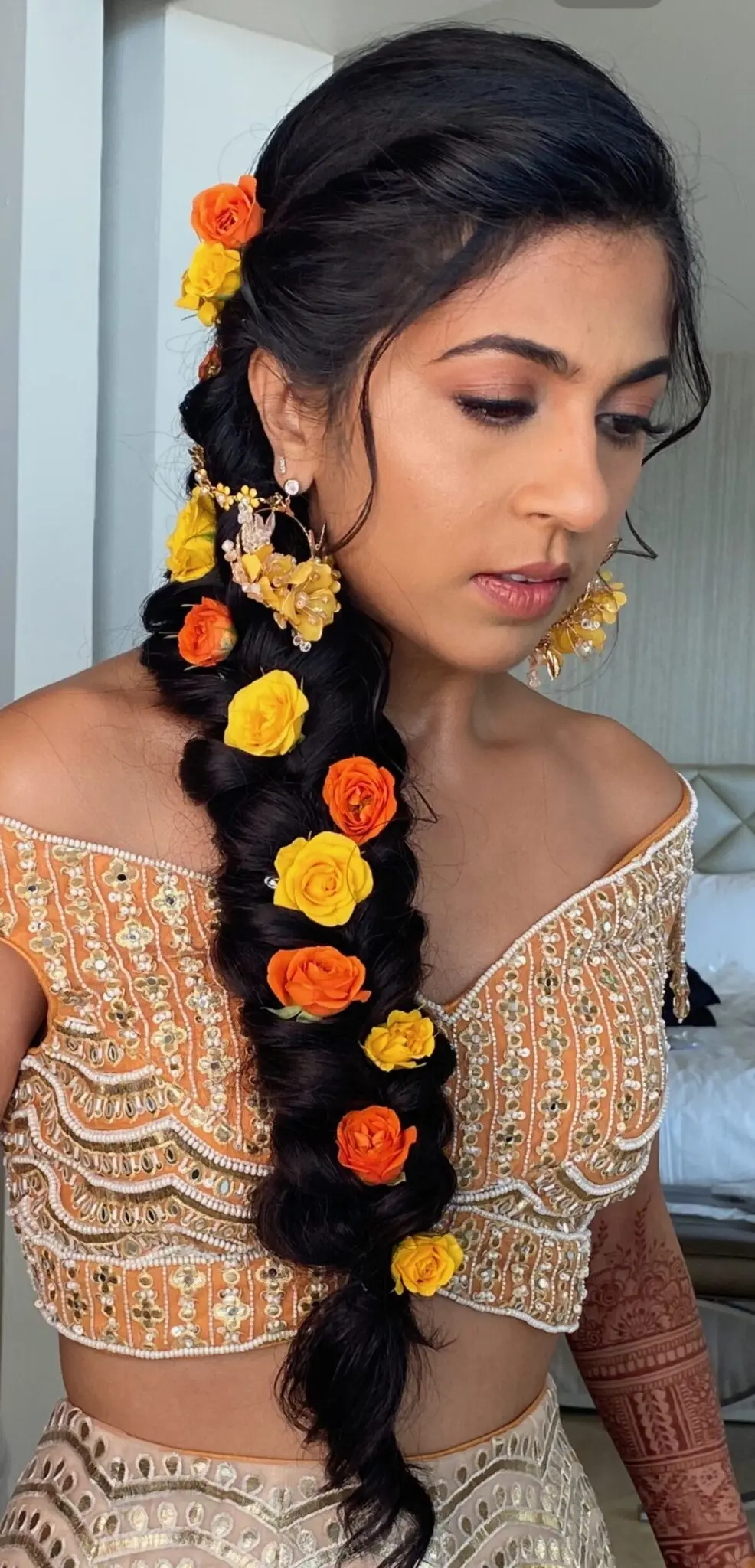 beautiful braid with flowers for sangeet night in Cancun for a gujarati wedding
