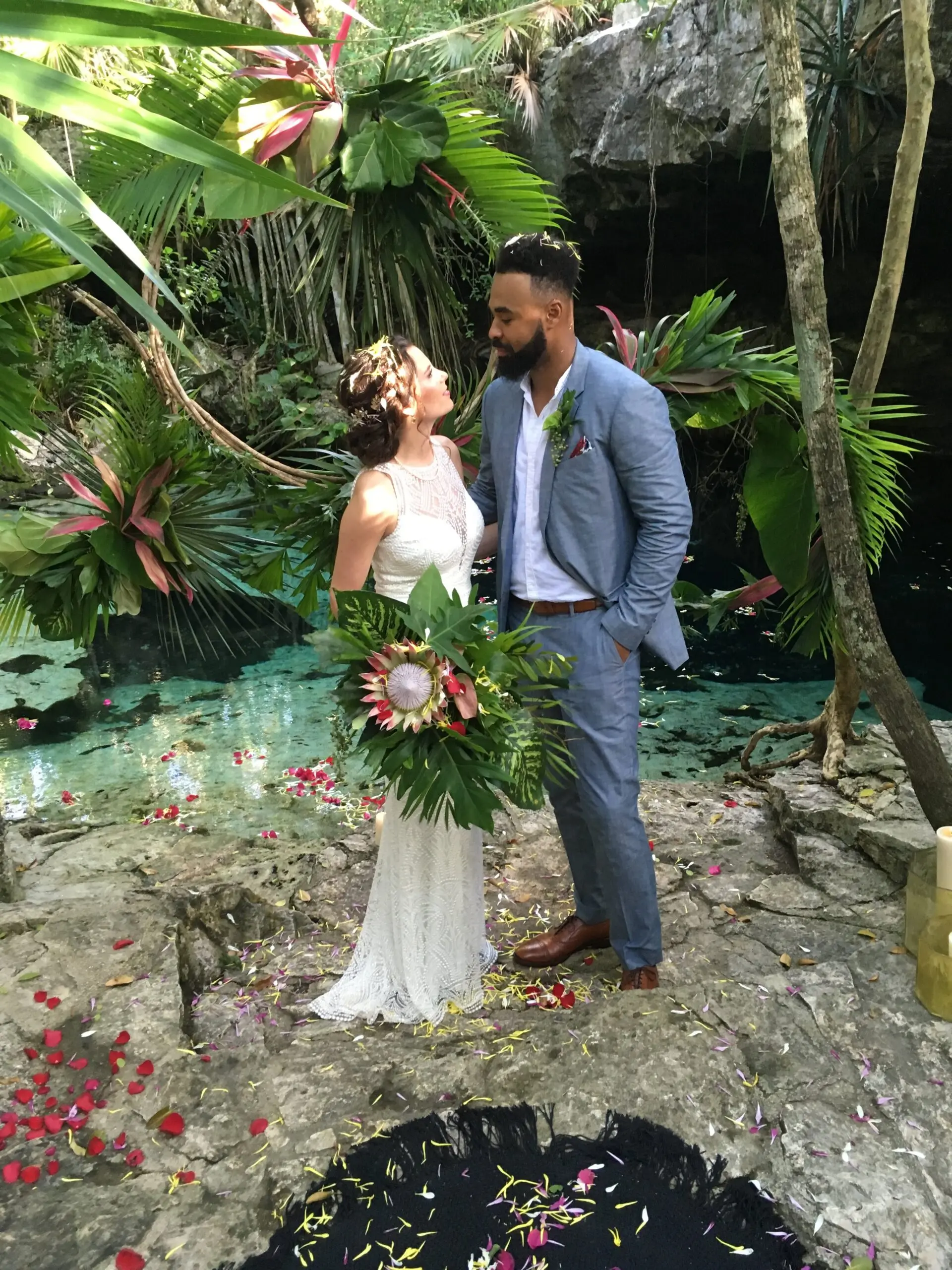 couple enjoy the Cenote Buho during their destination wedding photosession before their mayan ceremony in Puerto aventuras, riviera maya