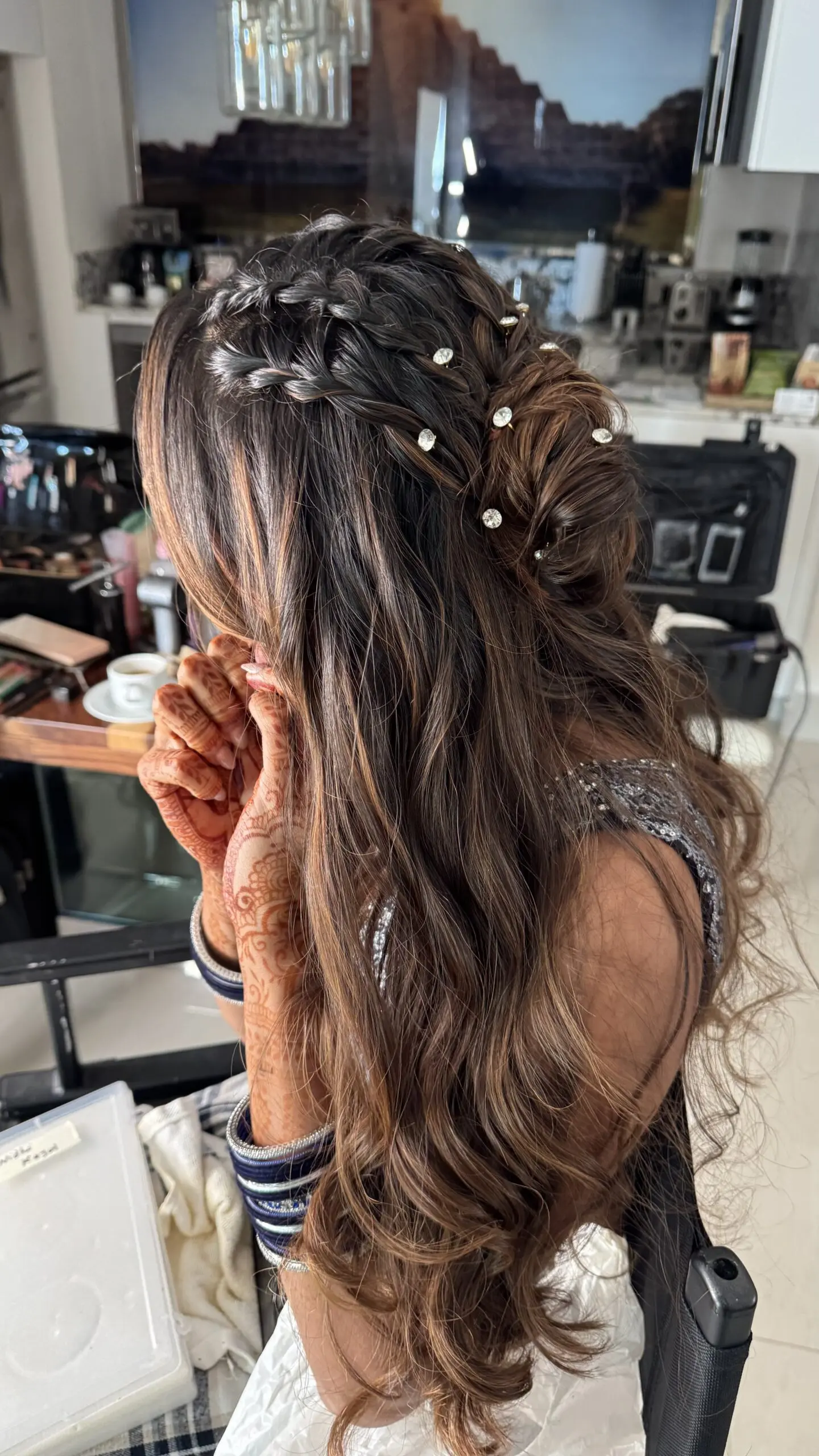 cute modern hairstyle with loose waves and bun with perls for bridal look on a destination wedding in Tulum